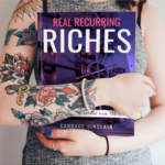 Girl with Tatooed arm holding book by Candace Sinclair titled Real Recurring Riches